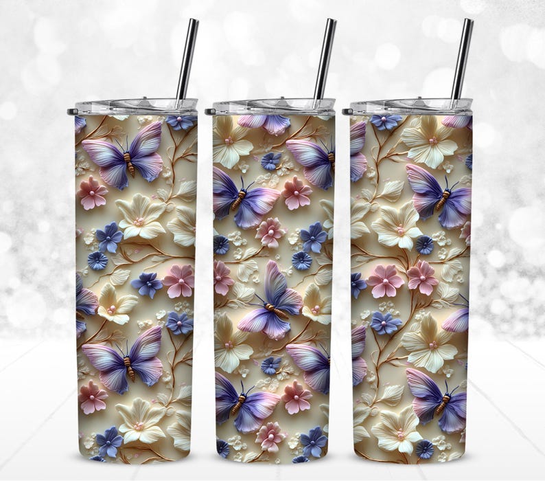 May include: Three stainless steel tumblers with a white background and a floral design featuring pink, purple, and blue butterflies.