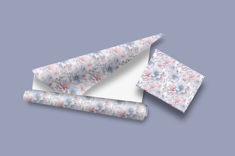 May include: A roll of floral patterned wrapping paper with pink and blue flowers. The paper is rolled up and partially unrolled, showing the pattern. There is also a small square of the same wrapping paper.