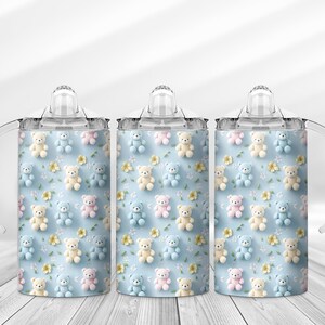 May include: Three baby sippy cups with a light blue background. The cups are decorated with a pattern of teddy bears in pastel colors and small yellow flowers. Each cup has a clear lid and handles.