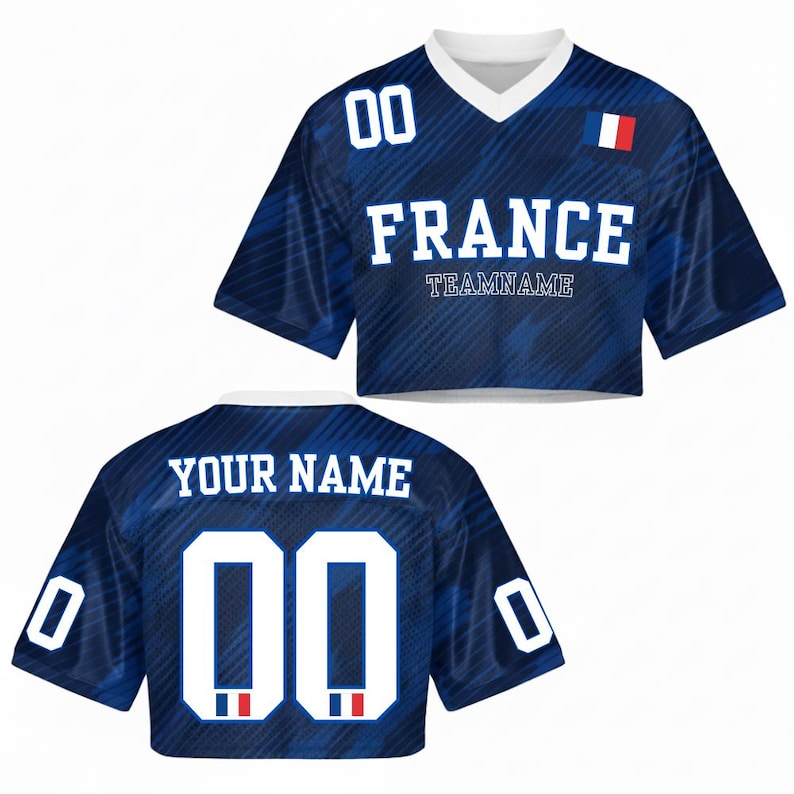 May include: A blue crop top jersey with the word "FRANCE" in white block letters and the number "00". The jersey has a V-neck collar and a small French flag patch. The back of the jersey says "YOUR NAME" and has the number "00".