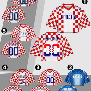 May include: A collection of Croatia-themed sports jerseys. The jerseys feature a red and white checkered pattern, with some in blue. Each jersey has the word "Croatia", a number "00", or space for a custom name. The jerseys are short-sleeved.