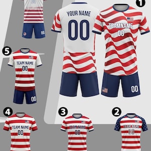May include: Soccer jerseys in red, white, and blue, featuring the American flag design. Each jersey has a team name and number, with matching blue shorts. The jerseys are displayed in various styles.