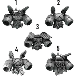 May include: Five grey miniature armour pieces, possibly for tabletop gaming or model building. Each piece has detailed designs, including vents, skulls, and wings. The pieces are numbered 1 to 5, showing different variations of the armour.