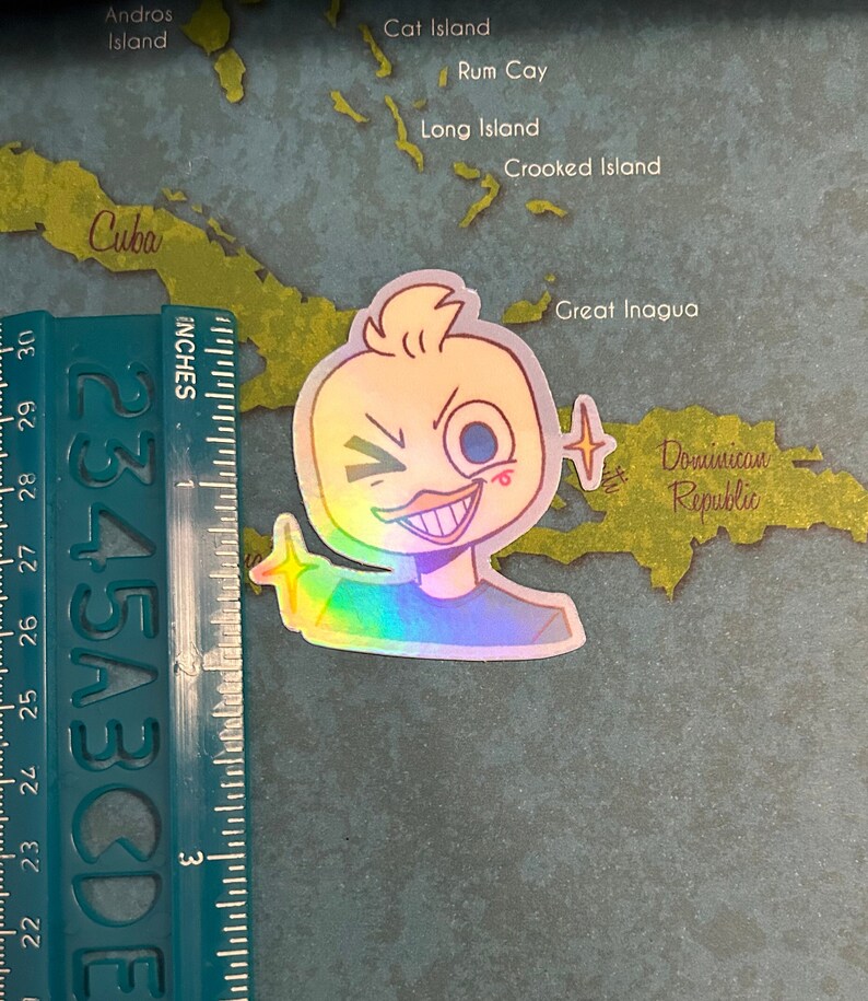 May include: A holographic sticker of a cartoon duck with a mischievous grin, winking, and holding up a finger. The duck is yellow with a blue eye and a red blush on its cheek. The sticker has a rainbow iridescent finish.