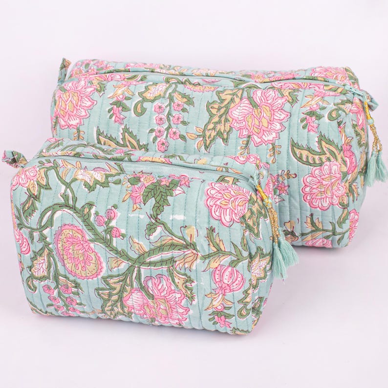 Size comparison of two block printed makeup pouches in a set