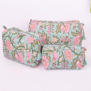 Size comparison of three block printed makeup pouches in a set