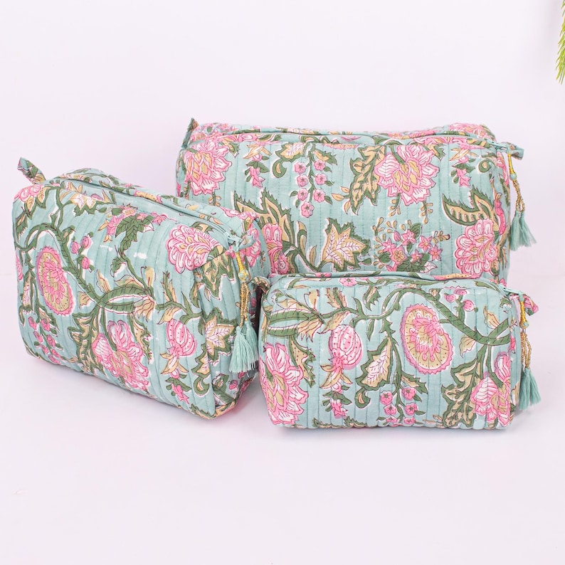 Size comparison of three block printed makeup pouches in a set
