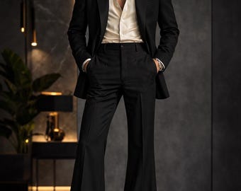 May include: A black suit with a matching jacket and flared pants. The suit is paired with a cream-colored button-down shirt and a gold chain necklace. The outfit is completed with black dress shoes.