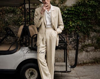May include: Beige linen suit with a white collared shirt. The suit includes a blazer and pleated trousers. Black leather shoes complete the outfit. A golf cart is in the background. The text "Falcon's Era" is on the golf cart.