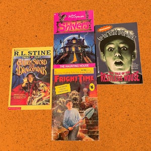 May include: A collection of vintage children's horror books, including titles like "Golden Sword of Dragonwalk" and "Are You Afraid of the Dark? The Tale of the Restless House." The books feature colorful covers with illustrations of spooky scenes.