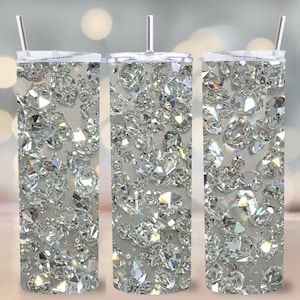 May include: Three stainless steel tumblers with clear lids and straws. The tumblers are covered in a sparkly silver diamond pattern.