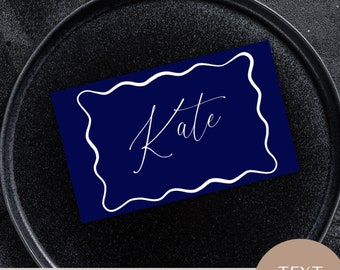 May include: Navy blue place card with a white wavy border and the name "Kate" written in white cursive script. The card is 2.5x1.5 inches and is editable.