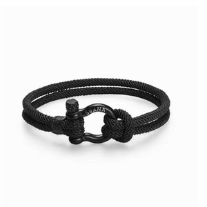 May include: Black rope bracelet with a black metal clasp. The clasp has the word "SVANA" engraved on it.