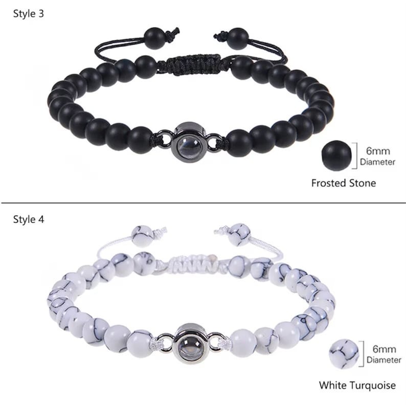 May include: Two styles of beaded bracelets with a small, round, silver-toned charm in the center. The first bracelet has black beads and the second bracelet has white beads with black marbling. The text "6mm Diameter" is next to a close-up of a bead from each bracelet. The text "Frosted Stone" is below the first bracelet and the text "White Turquoise" is below the second bracelet.