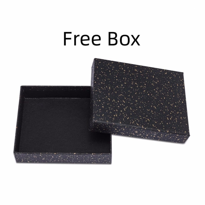 May include: An open black box with a speckled pattern and a matching lid. The box is empty and sits on a white background. The text "Free Box" is above the box.