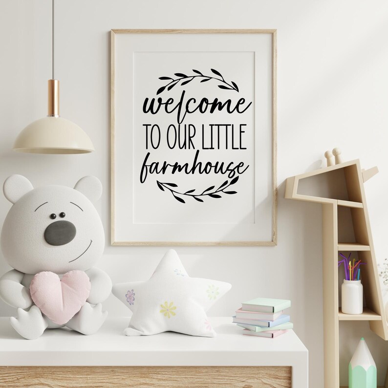 May include: Black and white printable wall art with the text "welcome to our little farmhouse" surrounded by a wreath of leaves.