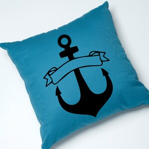 May include: A blue throw pillow with a black anchor and a banner. The banner is blank and can be personalized.
