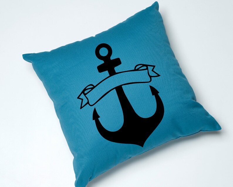 May include: A blue throw pillow with a black anchor and a banner. The banner is blank and can be personalized.