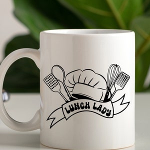 May include: White ceramic mug with a black and white illustration of a chef's hat, kitchen utensils, and the text "Lunch Lady".