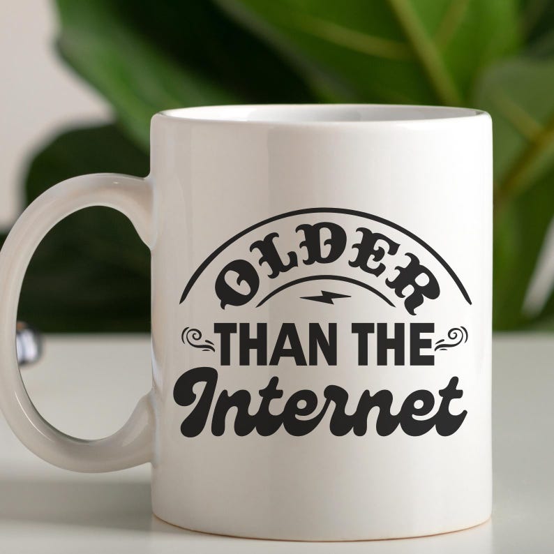 May include: White ceramic mug with a black design that says "Older than the Internet".