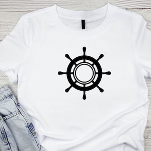 May include: White t-shirt with a black ship's wheel design.