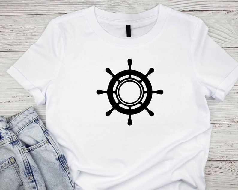 May include: White t-shirt with a black ship's wheel design.
