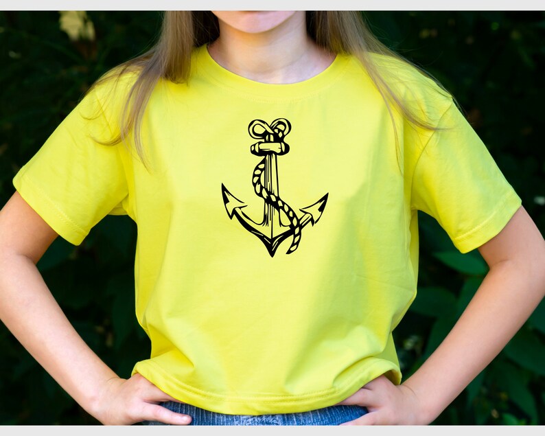 May include: A yellow t-shirt with a black anchor graphic. The anchor is drawn in a nautical style with a rope wrapped around it.