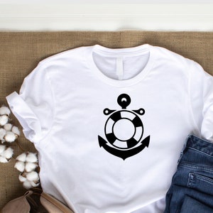 May include: White t-shirt with a black anchor and life preserver design.