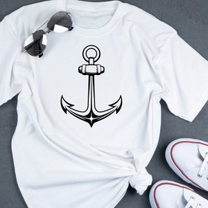 May include: White t-shirt with a black anchor graphic design.