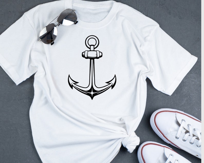May include: White t-shirt with a black anchor graphic design.