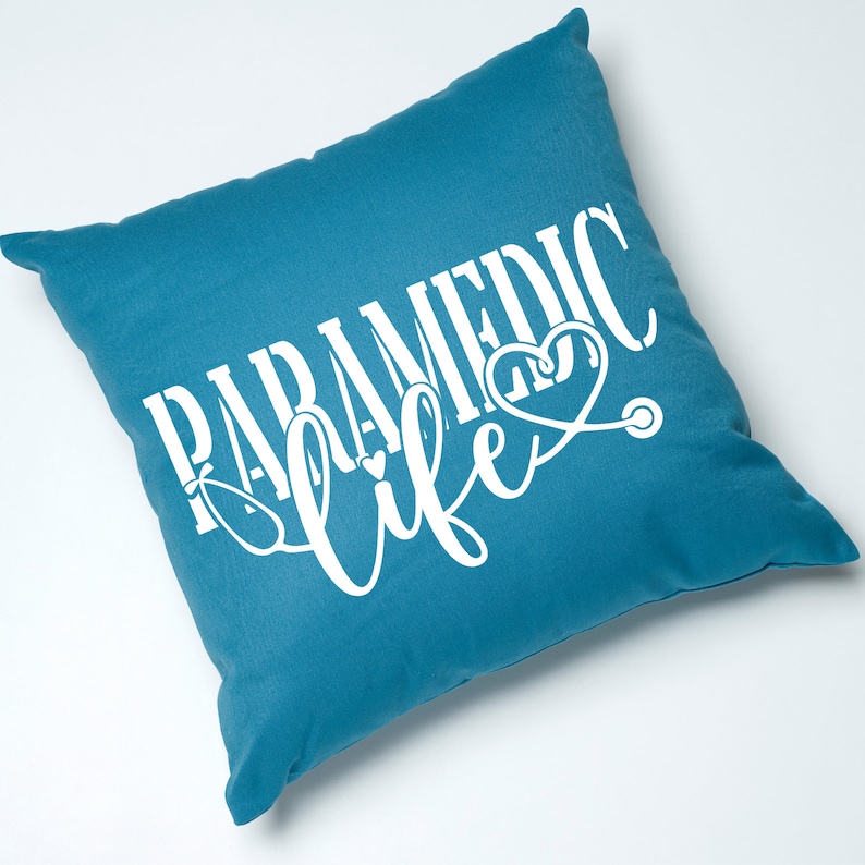 May include: Teal blue throw pillow with white text that reads "PARAMEDIC life" with a stethoscope and heart graphic.