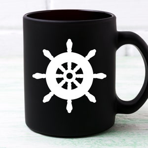 May include: Black ceramic coffee mug with a white ship's wheel design.