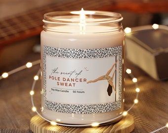 May include: A clear glass candle jar with a beige soy wax candle inside. The candle jar has a label with a leopard print design and the text "The scent of Pole Dancer Sweat Soy Wax Candle 50 hours".