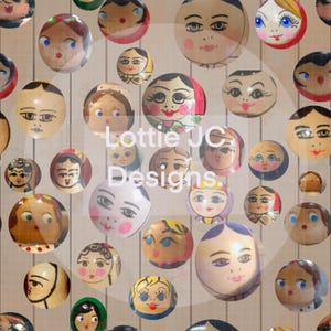 May include: A collection of round, wooden Matryoshka dolls with painted faces and colorful details. The dolls vary in size and feature different hairstyles and facial expressions. The text "Lottie JC Designs" is visible in the center.