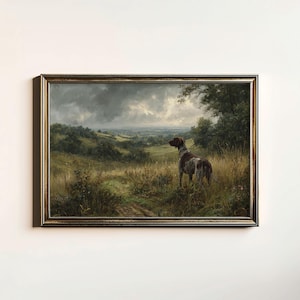 May include: A framed landscape painting with a dog in a field. The artwork shows a brown and white dog standing in long grass, overlooking a valley under a cloudy sky. The frame is a dark, ornate gold colour.