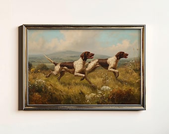 May include: A framed vintage painting shows two brown and white dogs in full stride, running through a field of long grass and wildflowers. The background features rolling hills and a cloudy sky, typical of a rural landscape.