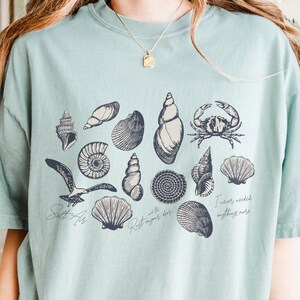 Salt air, rust on your door, coastal vibes graphic tee with shells and coastal creatures.