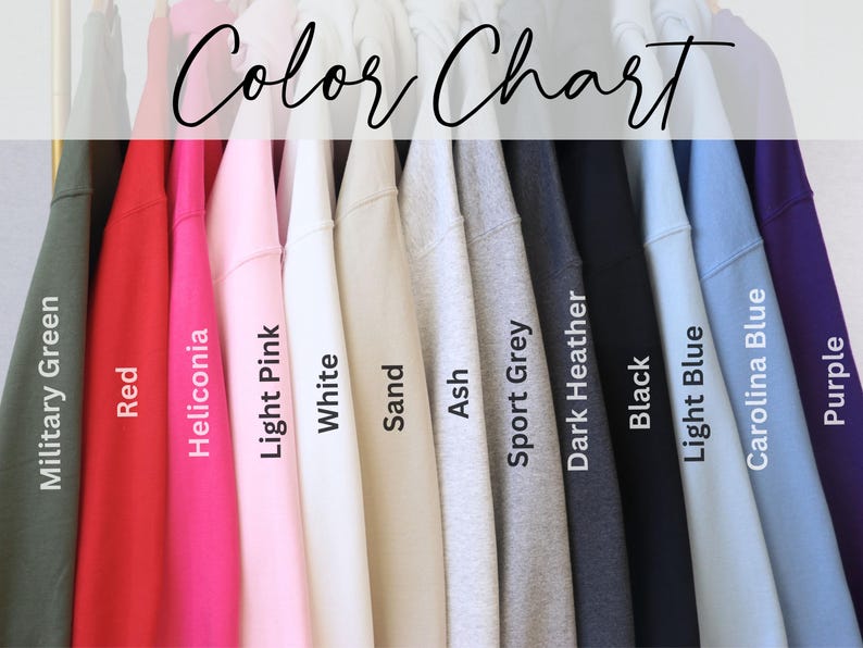 May include: Color chart showing 13 different sweatshirt colors: military green, red, heliconia, light pink, white, sand, ash, sport grey, dark heather, black, light blue, carolina blue, and purple.