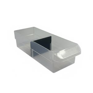 May include: A clear plastic storage bin with a black divider. The bin has a rectangular shape with a handle on one end. The bin is designed to organize items and is made of transparent plastic.