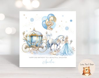 May include: A square birthday card with a fairytale theme. It features a blue and gold carriage, a white horse, and a princess in a blue gown. Balloons shaped like the number 2 float above. The text reads, "Happy 2nd Birthday to a Beautiful Daughter" and "Amelia."