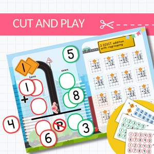 May include: A colourful educational worksheet with the text "CUT AND PLAY" and "2 DIGIT addition with regrouping". The worksheet features addition problems, a road-themed addition layout, and number cards for learning.