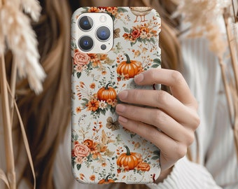 May include: A smartphone case featuring a repeating pattern of orange pumpkins, autumn flowers, and foliage on a light background. The design includes various floral elements, berries, and leaves in shades of orange, brown, and muted green.