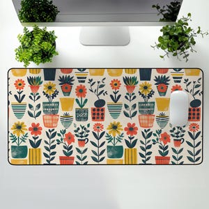 May include: A colorful mousepad with a repeating pattern of potted plants in various colors and styles. The background is a light cream color.