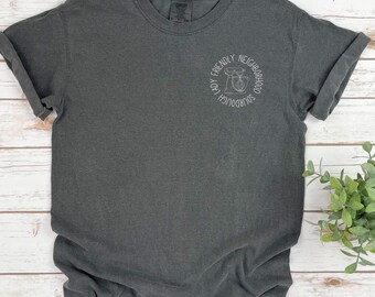 May include: Dark grey t-shirt with a crew neck and short sleeves. A white circular graphic on the left chest reads "Friendly Neighborhood Sourdough Lady" with a mixer illustration. The shirt is made of a soft, comfortable material.
