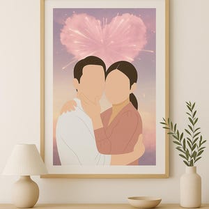 May include: A framed art print featuring a couple embracing, set against a backdrop of a heart-shaped design with pink and purple hues. The artwork is displayed on a light-colored wooden cabinet, with a lamp and vase nearby.