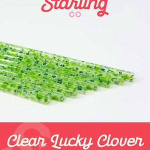 May include: A pack of 40 ounce clear plastic straws with a green shamrock and horseshoe pattern. The straws are made by Sweet Starling Co.
