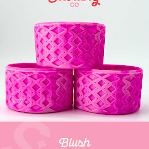 May include: Three stacked, vibrant pink containers with a diamond pattern. The containers are cylindrical and have a textured surface. The top of the image features the text "Sweet Starling Co" in red script. The bottom of the image features the text "Blush MINI".