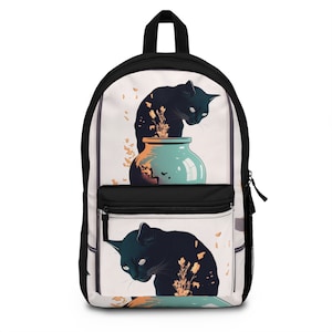 May include: Black and white backpack featuring a stylized illustration of two black cats interacting with a teal vase. The backpack has a black top handle, a front pocket, and a zipper closure.