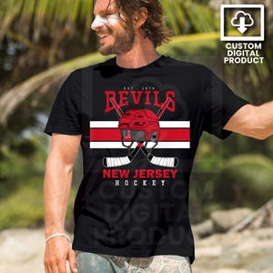 May include: Black t-shirt featuring a hockey design with the word "Devils" in red, a red helmet, and crossed hockey sticks. The text "New Jersey Hockey" is below the sticks. The shirt has a white and red stripe.