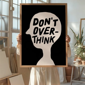 May include: A black and white poster with a white silhouette of a head and the text "DON'T OVER-THINK" in white.